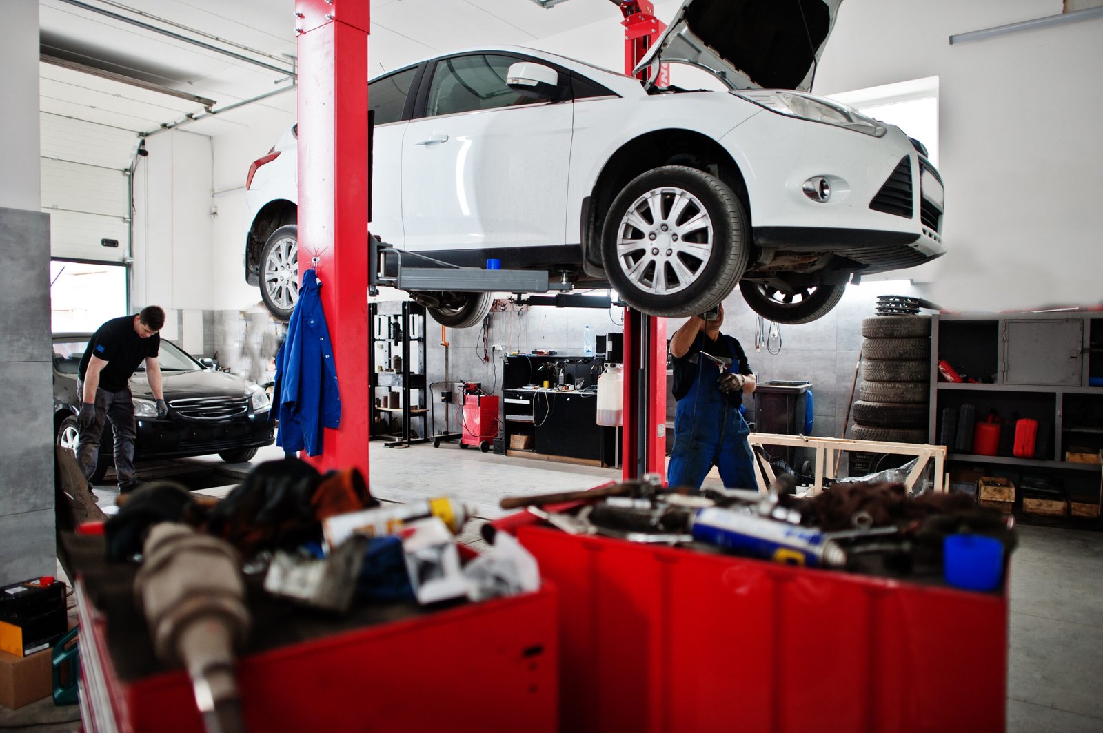 Car repair and maintenance theme. Mechanic in uniform working in Car repair and maintenance mega auto theme. Mechanic in uniform working in mega auto service.